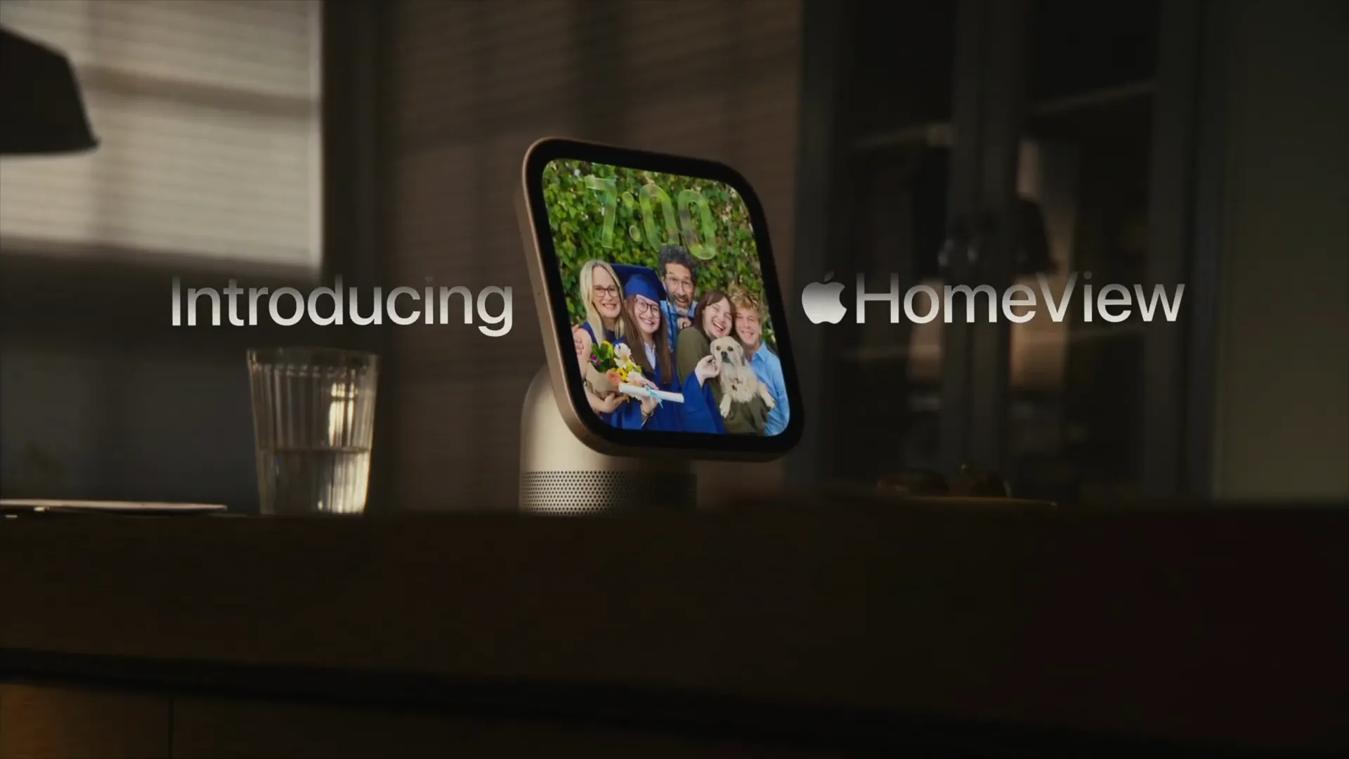 Apple HomeView device displaying family photos on a dark countertop
