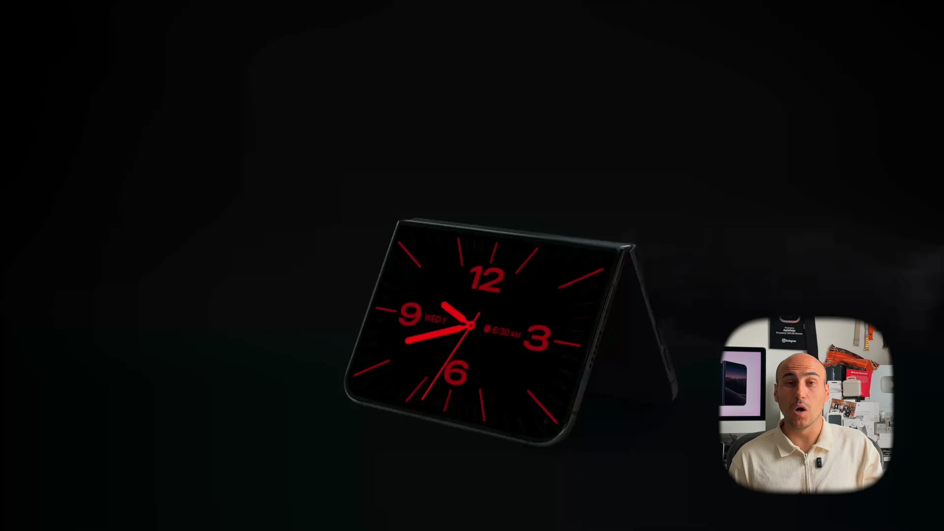 iPhone Duo resting in tent mode on a nightstand displaying a red digital clock