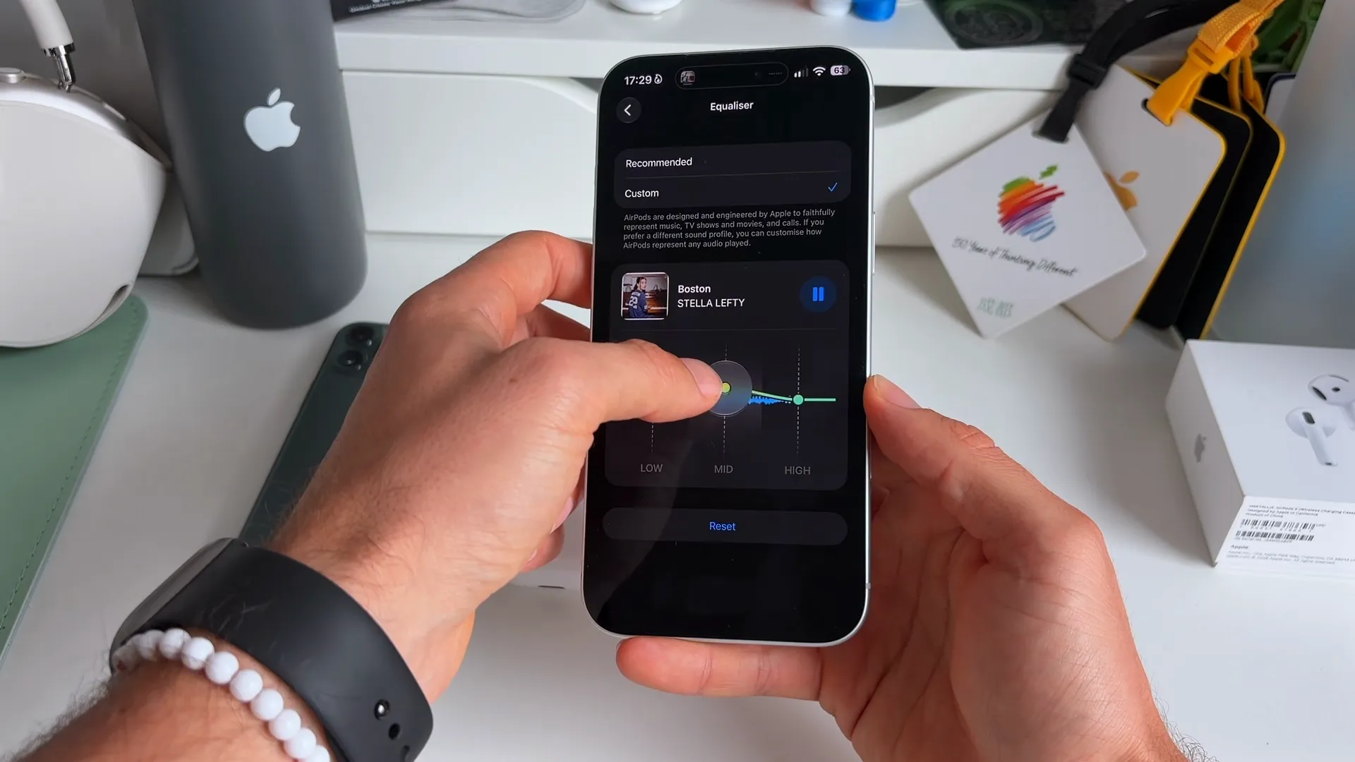 AirPods Equalizer settings showing a custom EQ curve being adjusted while a song plays