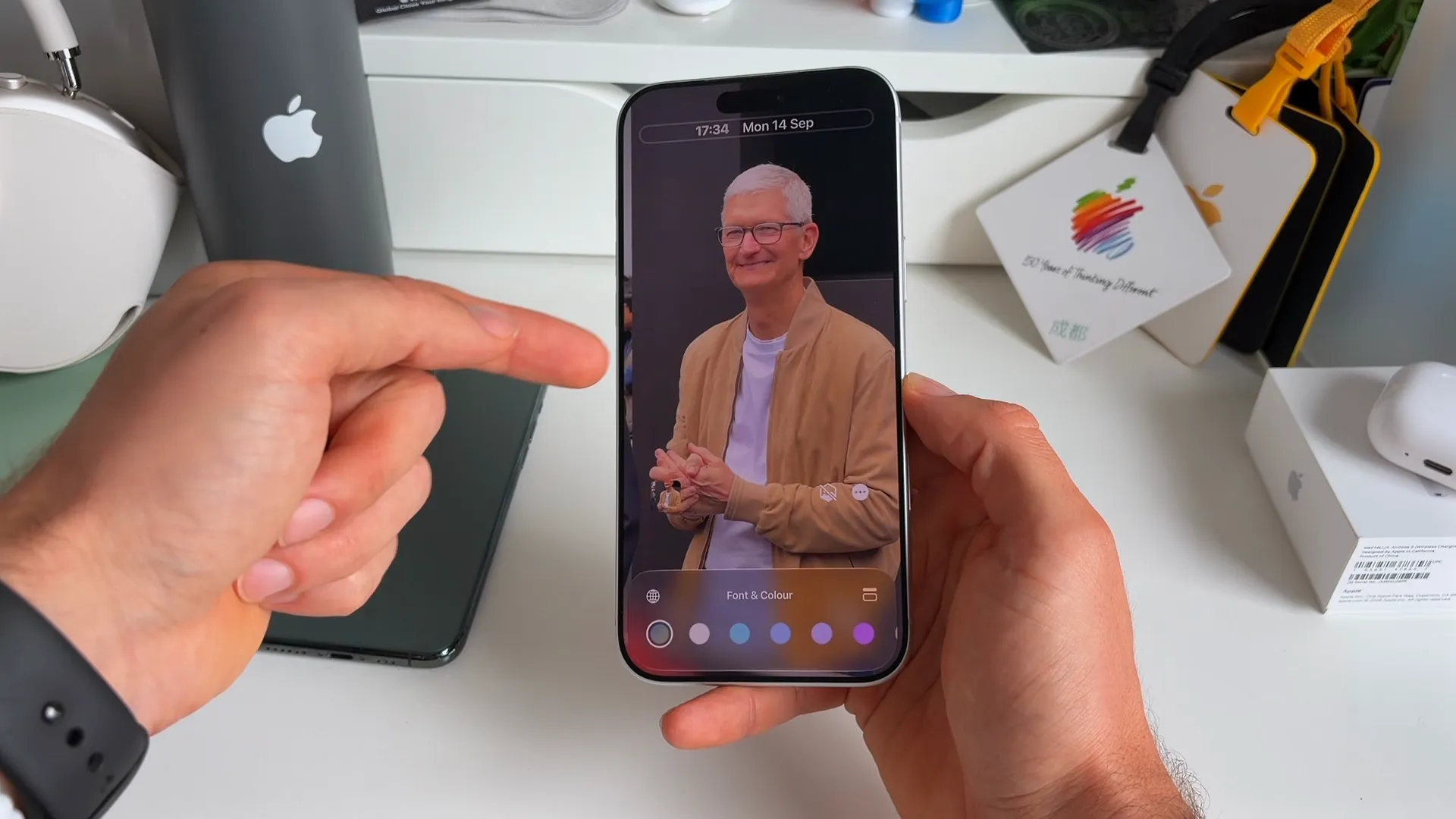 Lock screen customization showing a smaller clock moved to the top right corner over a photo of Tim Cook